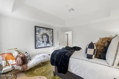 a backyard of a house with barbeque oven and large trees