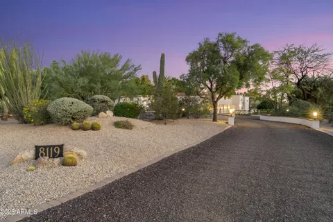 a living room with furniture a fireplace and a floor to ceiling window
