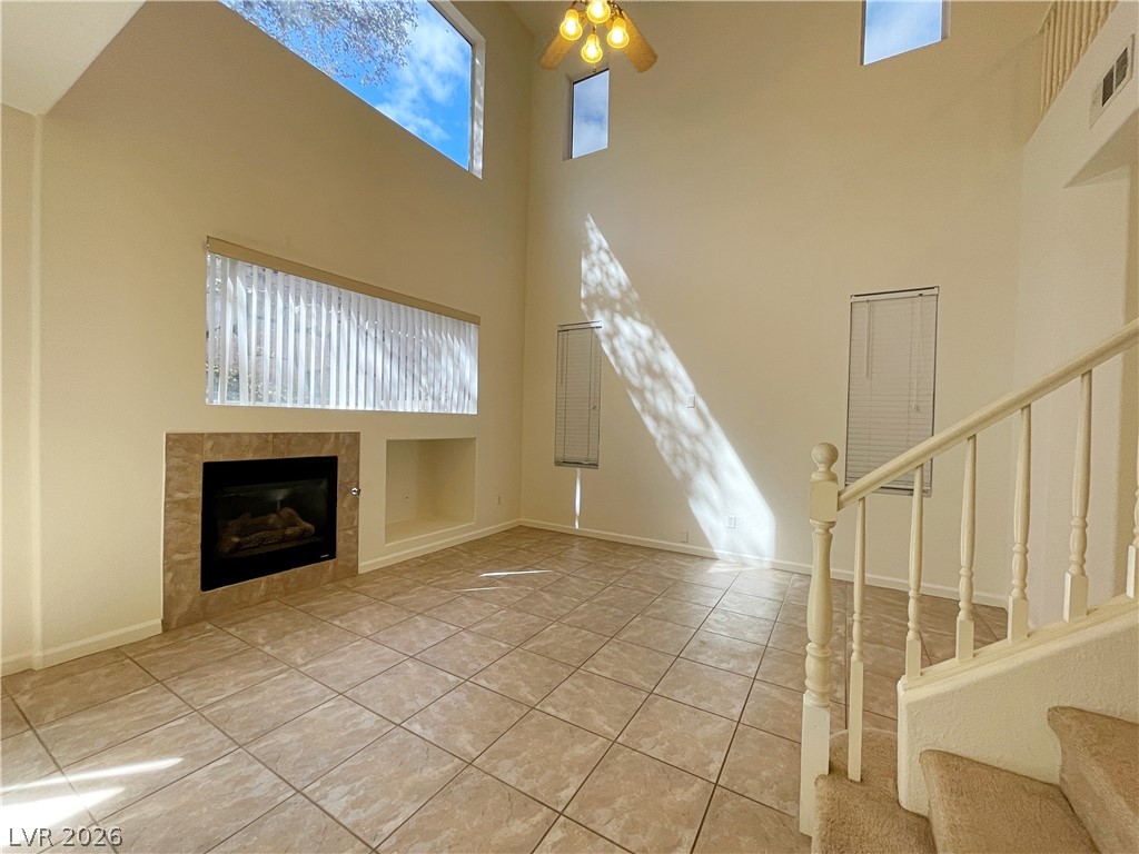 691 Principle Point Avenue Henderson, NV 89012 - Photo 6 of 30 A spacious living room with soaring ceilings, a cozy fireplace, and abundant natural light.
