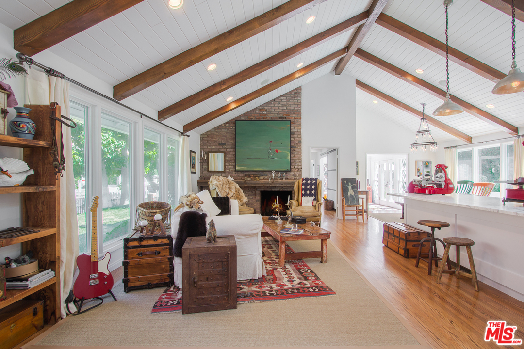 1538 Roscomare Road Los Angeles, CA 90077 - Photo 1 of 26 a living room with furniture a fireplace and a large window
