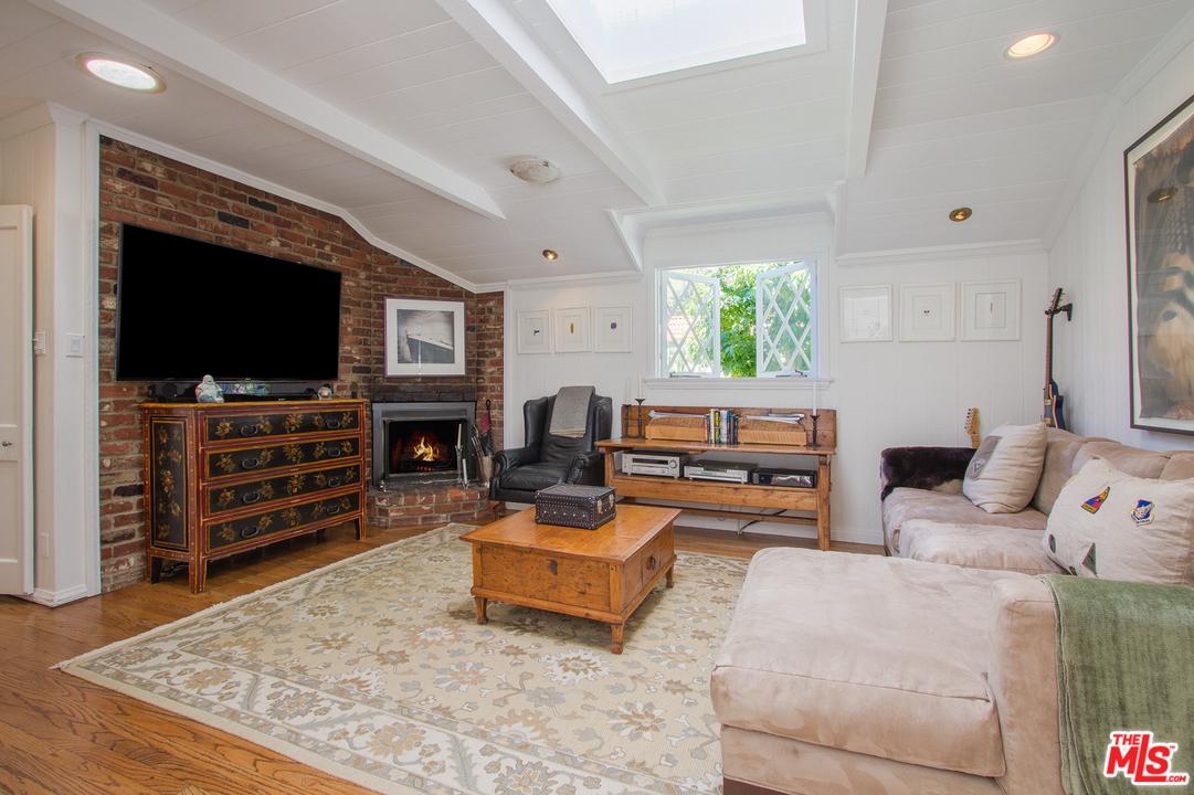 1538 Roscomare Road Los Angeles, CA 90077 - Photo 13 of 26 a living room with furniture and a flat screen tv
