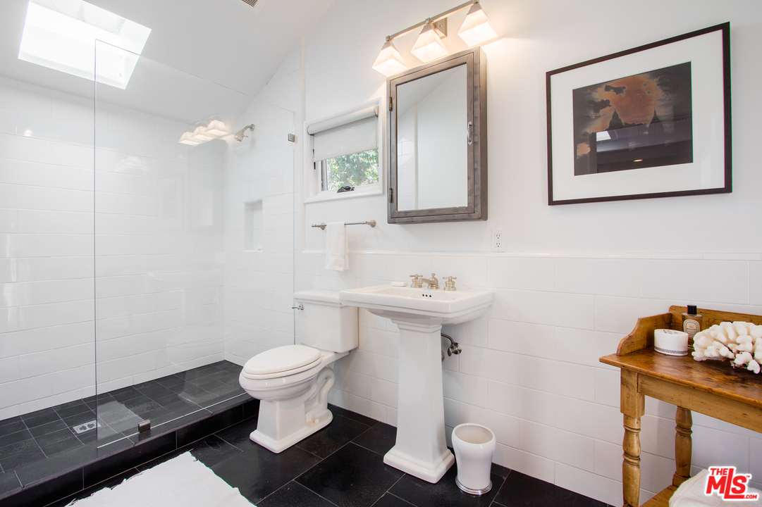 1538 Roscomare Road Los Angeles, CA 90077 - Photo 14 of 26 a white toilet sitting next to a bathroom sink