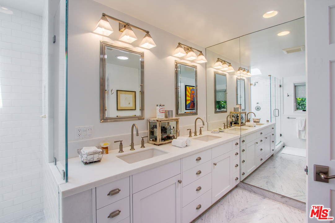 1538 Roscomare Road Los Angeles, CA 90077 - Photo 16 of 26 a bathroom with double sink and a mirror