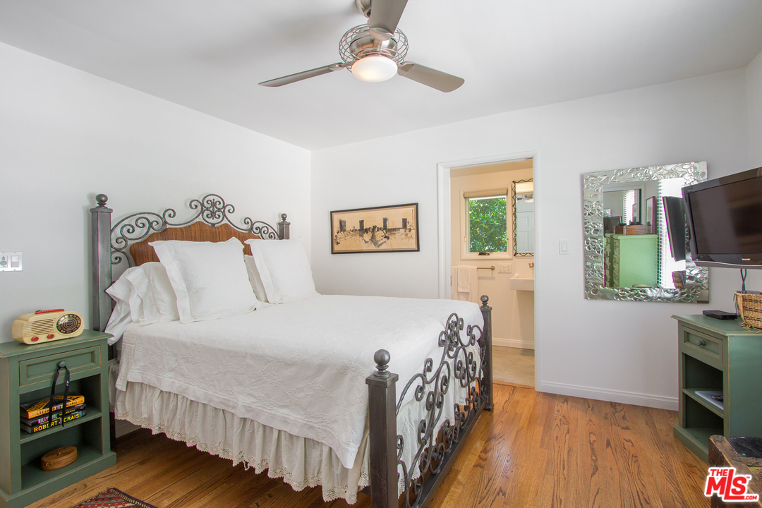 1538 Roscomare Road Los Angeles, CA 90077 - Photo 18 of 26 a bedroom with a bed and a flat tv screen on dresser