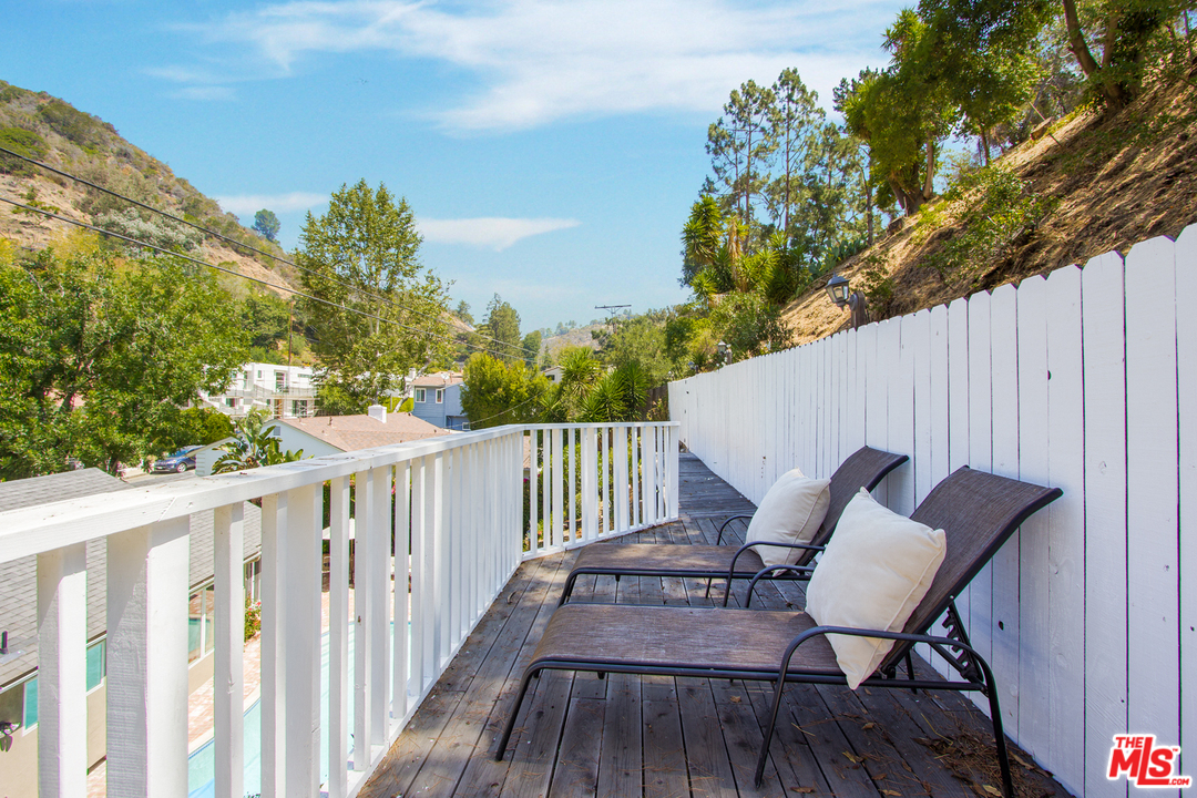 1538 Roscomare Road Los Angeles, CA 90077 - Photo 25 of 26 a view of balcony with wooden floor and outdoor seating