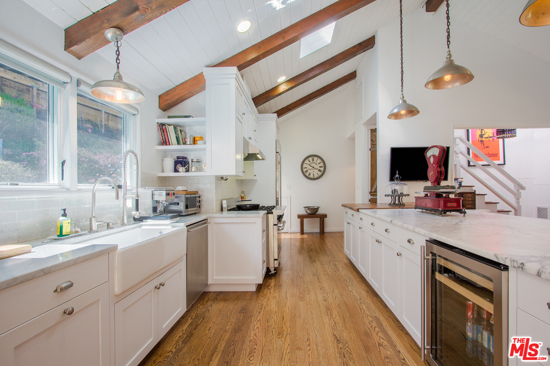 1538 Roscomare Road Los Angeles, CA 90077 - Photo 4 of 26 a large kitchen with a sink wooden floor and stainless steel appliances