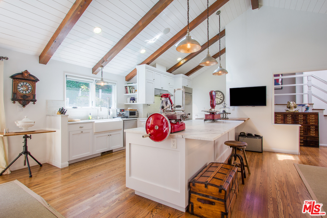 1538 Roscomare Road Los Angeles, CA 90077 - Photo 5 of 26 a view of a workspace with furniture and wooden floor