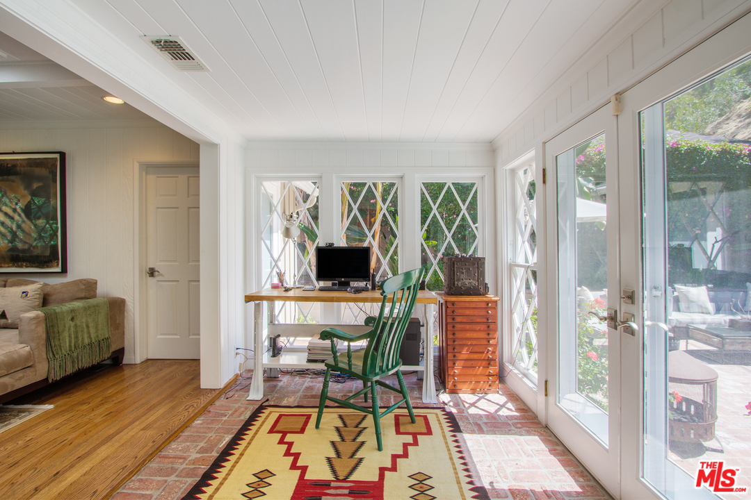 1538 Roscomare Road Los Angeles, CA 90077 - Photo 10 of 26 a living room with furniture a flat screen tv and a floor to ceiling window