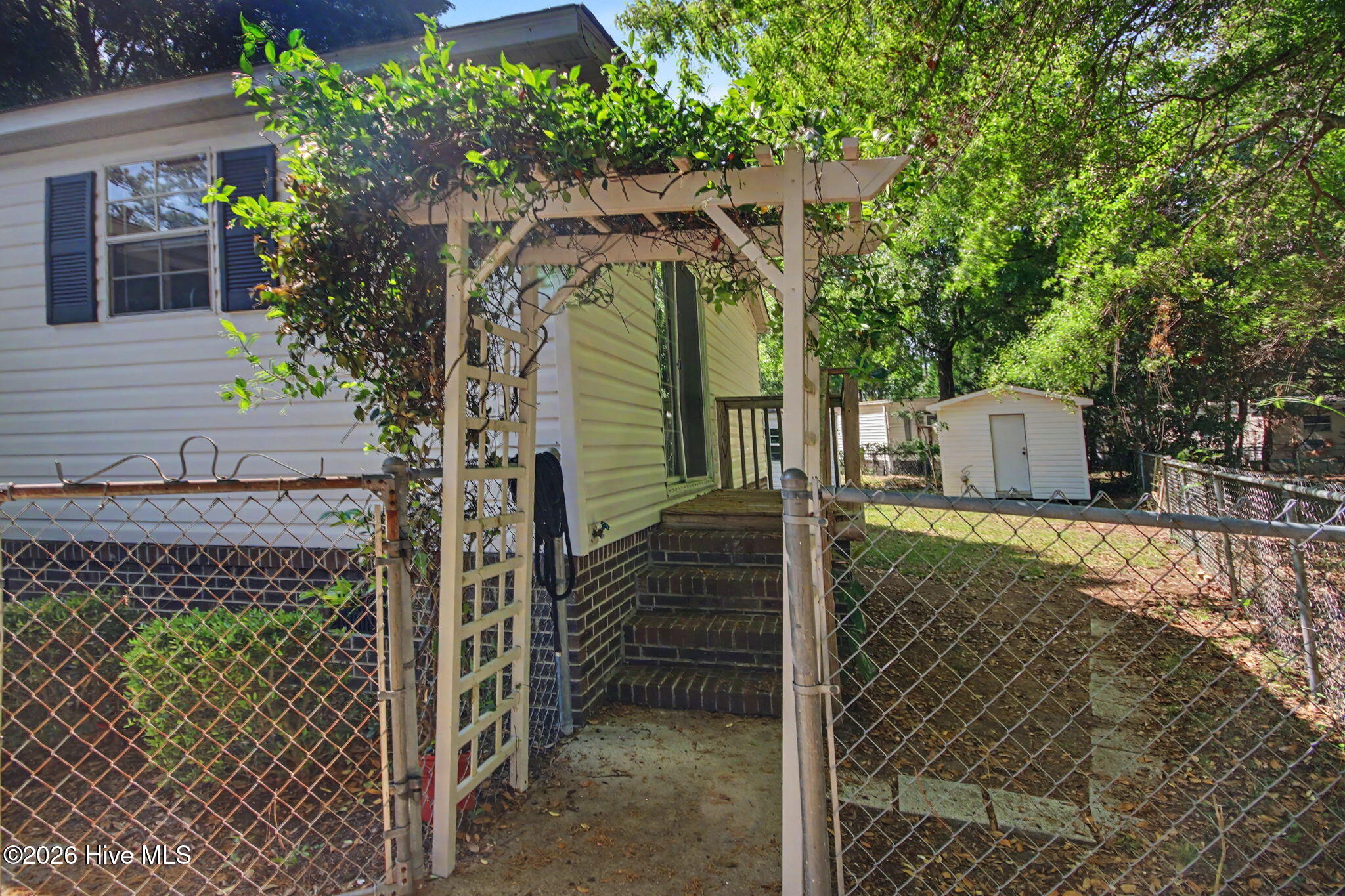 9157 Riveredge Place Southwest Calabash, NC 28467 - Photo 17 of 34 Lovely entry canopy into the fully fenced backyard