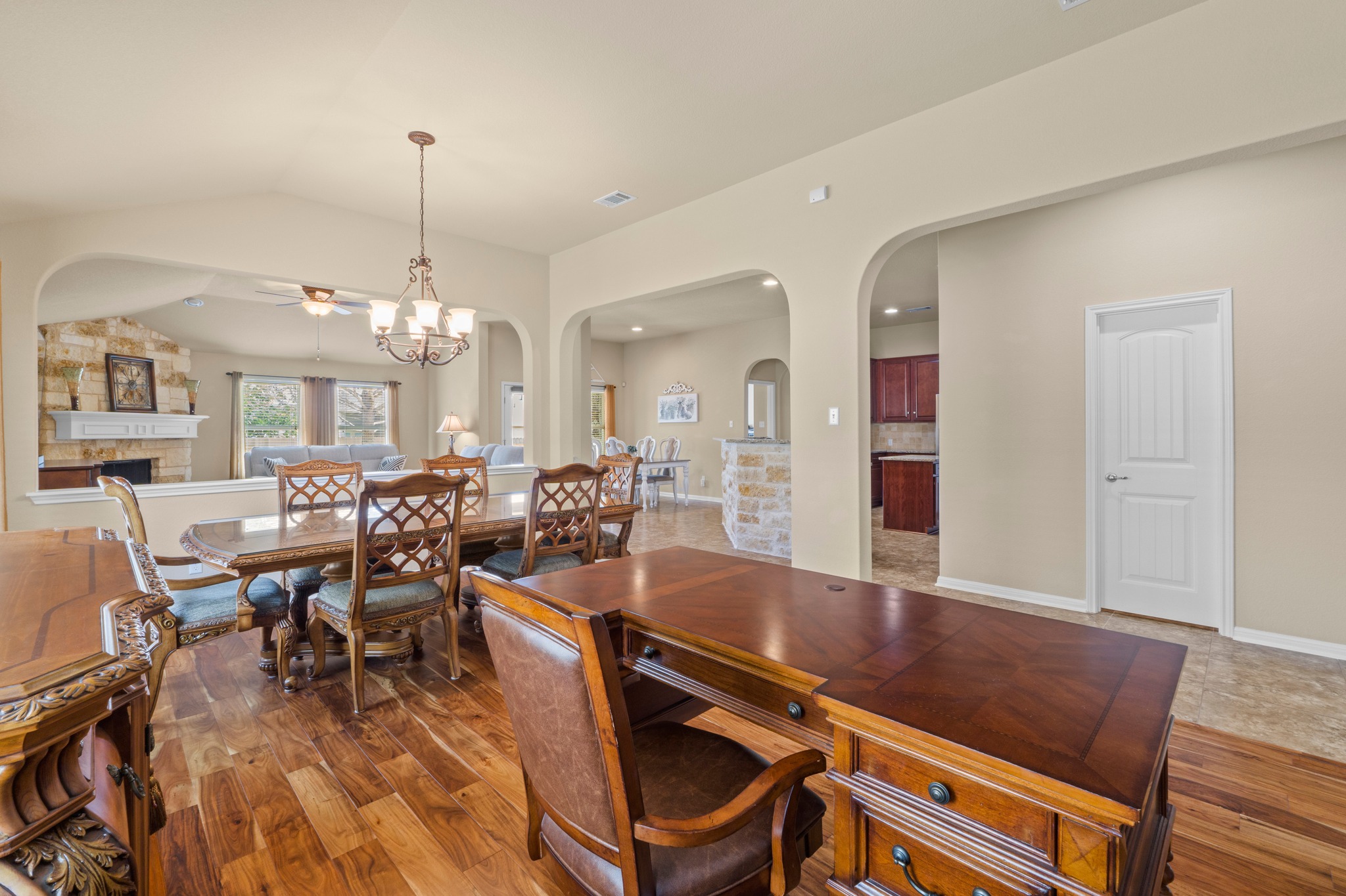 20525 Jackies Ranch Boulevard Pflugerville, TX 78660 - Photo 12 of 27 Dining area with chandelier and study with arched walkways. Acacia wood engineered flooring