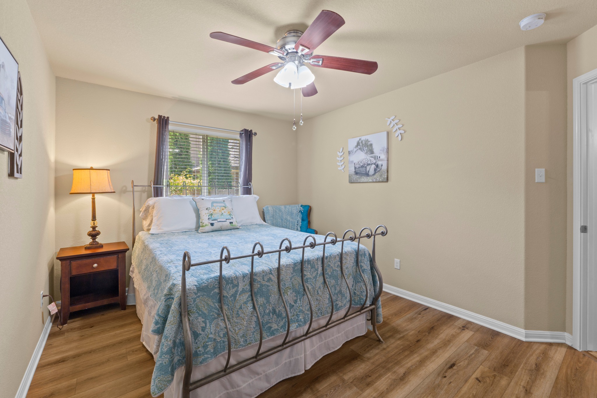 20525 Jackies Ranch Boulevard Pflugerville, TX 78660 - Photo 20 of 27 Bedroom featuring ceiling fan and wood look finished floors. Roomy closet.