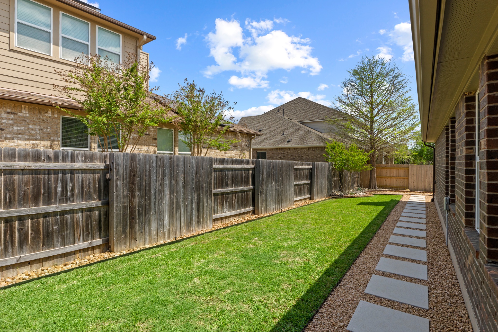 20525 Jackies Ranch Boulevard Pflugerville, TX 78660 - Photo 25 of 27 View of fenced backyard and custom walkway just outside the back door of garage