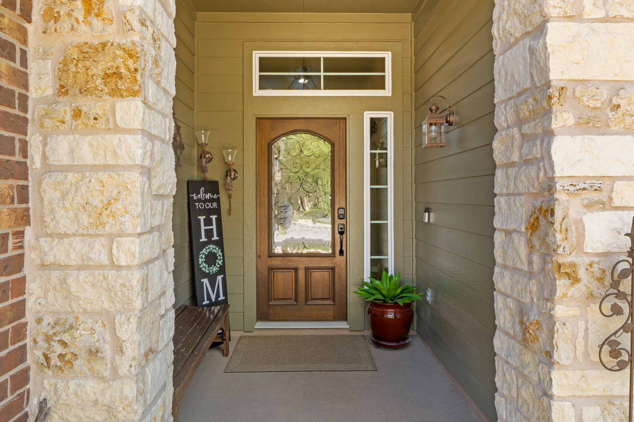 20525 Jackies Ranch Boulevard Pflugerville, TX 78660 - Photo 3 of 27 View of exterior entry featuring stone siding and a porch