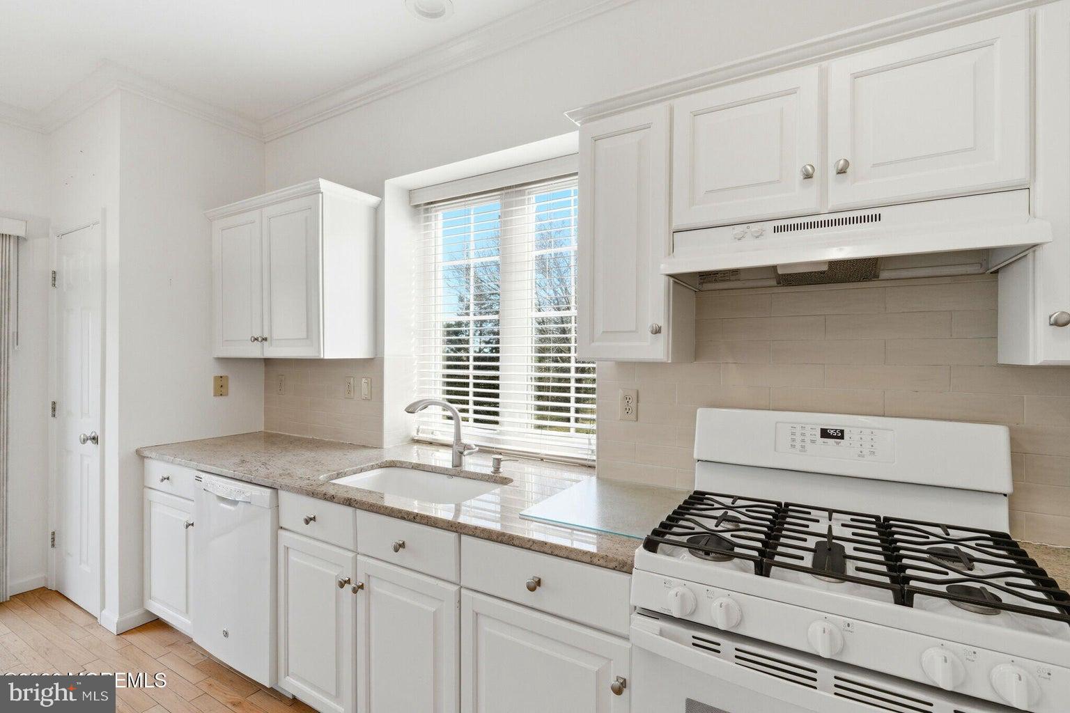11 Ripple Terrace Barnegat, NJ 08005 - Photo 19 of 64 a kitchen with granite countertop a stove a sink and white cabinets