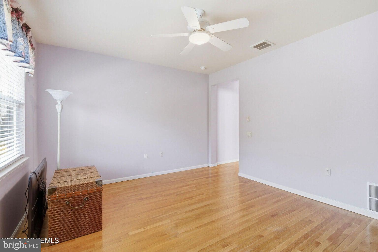 11 Ripple Terrace Barnegat, NJ 08005 - Photo 25 of 64 an empty room with wooden floor and fan