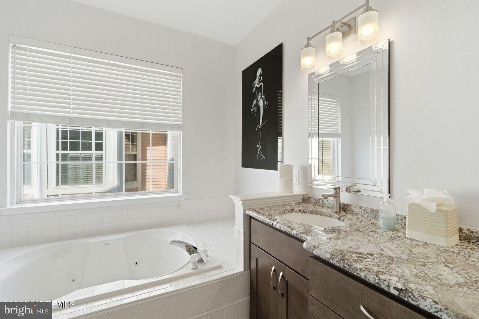 11 Ripple Terrace Barnegat, NJ 08005 - Photo 28 of 64 a bathroom with a granite countertop sink and a bathtub