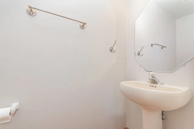 a bathroom with a sink and mirror
