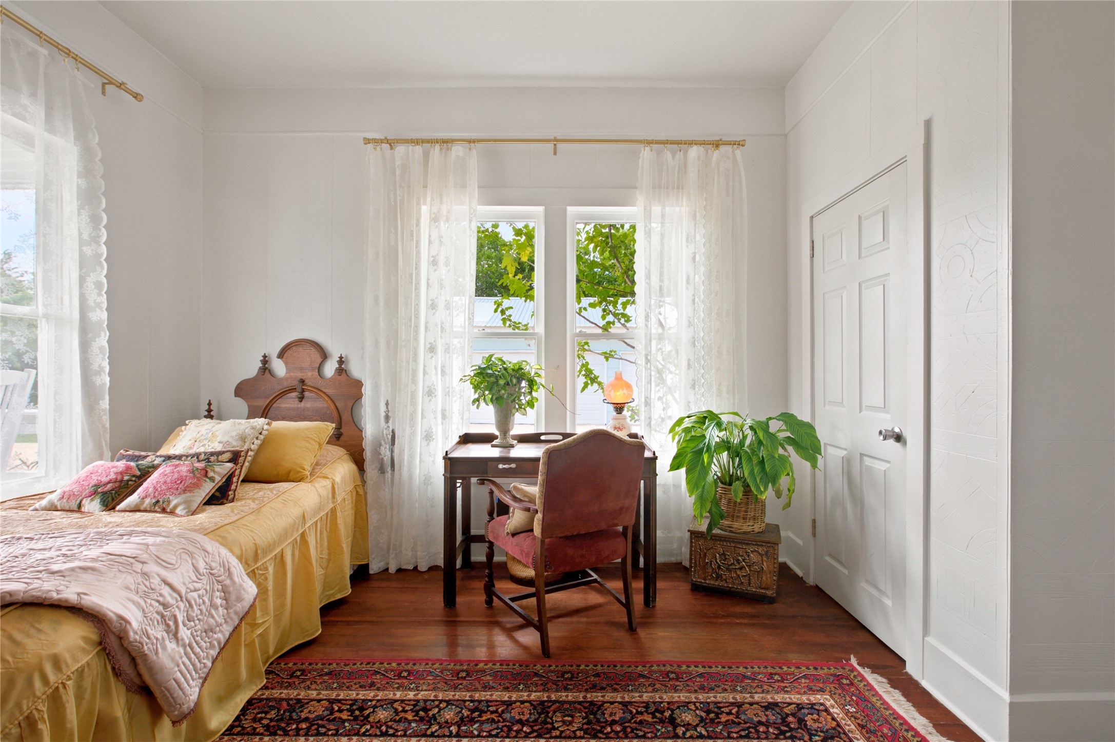 372 Old Lockhart Road Lockhart, TX 78644 - Photo 24 of 40 Sun-filled bedroom featuring beautiful hardwood flooring and large windows, perfect for serene mornings.