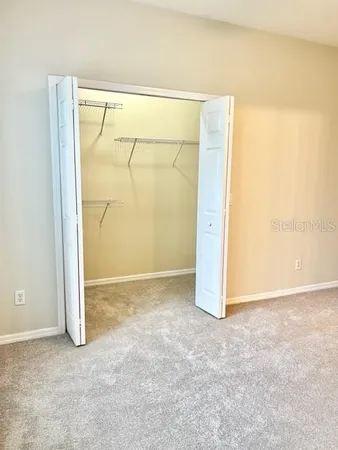a bathroom with a granite countertop sink a toilet and a mirror