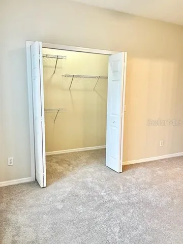 a bathroom with a granite countertop sink a toilet and a mirror
