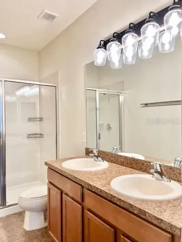 an empty room with a window and a ceiling fan