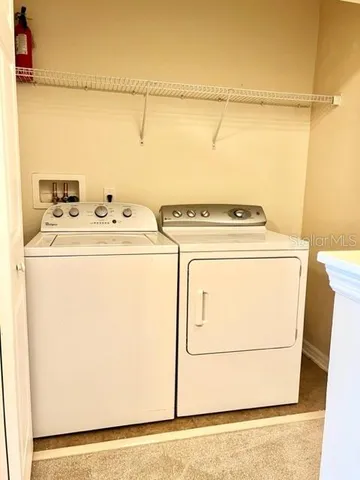 a view of a park with a bench and table under an umbrella