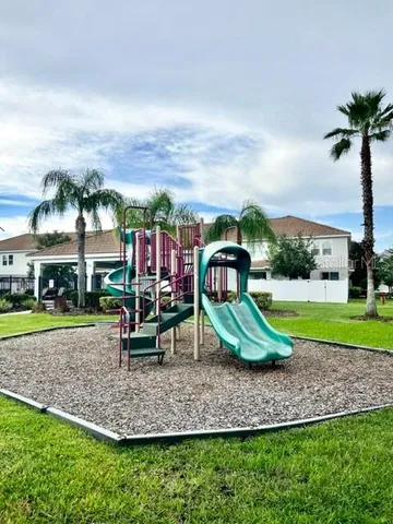 a swimming pool with barbeque oven in front of it