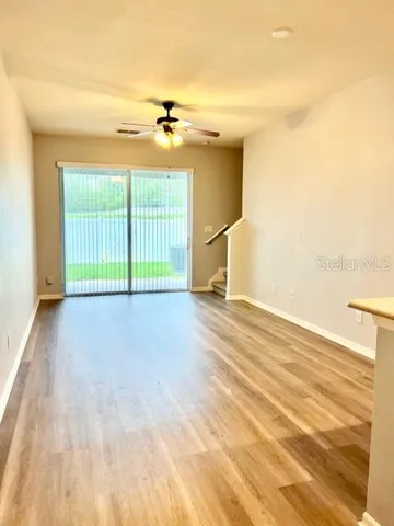 a view of empty room with wooden floor
