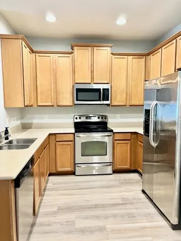 a kitchen with a stove a sink and a microwave