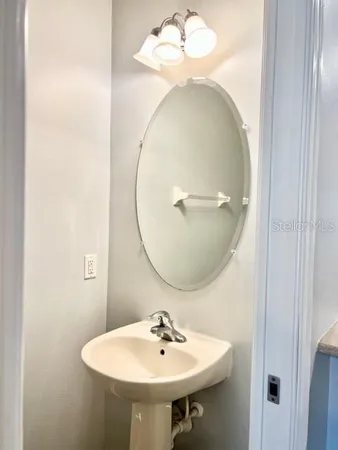 a bathroom with a sink a mirror and a toilet