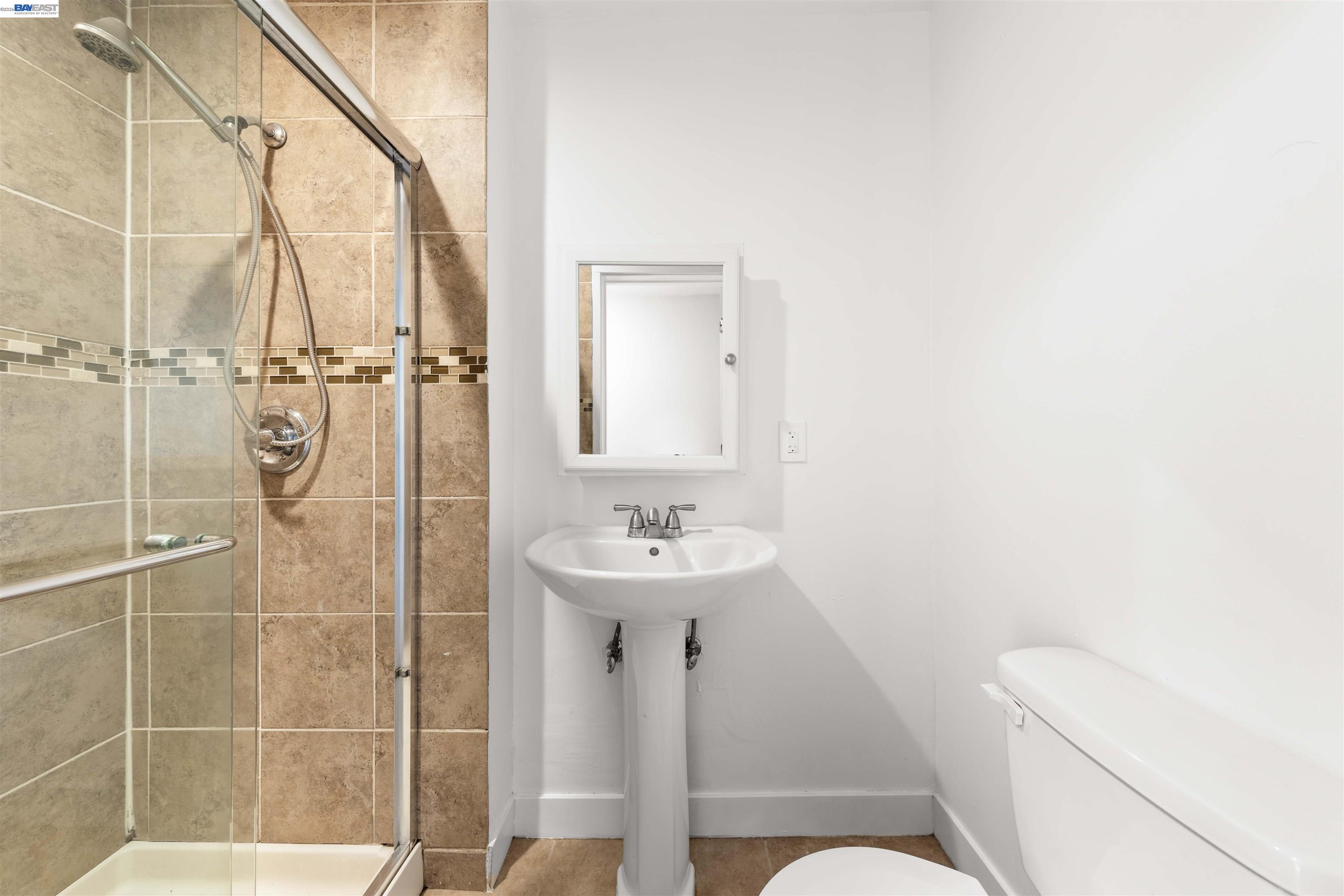 2102 Overhill Road Concord, CA 94520 - Photo 19 of 38 a bathroom with a sink a toilet and shower