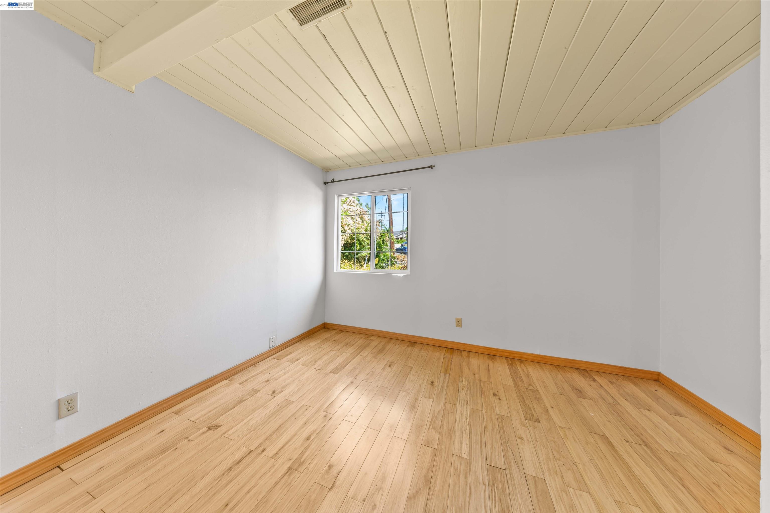 2102 Overhill Road Concord, CA 94520 - Photo 20 of 38 a view of an empty room with window and wooden floor