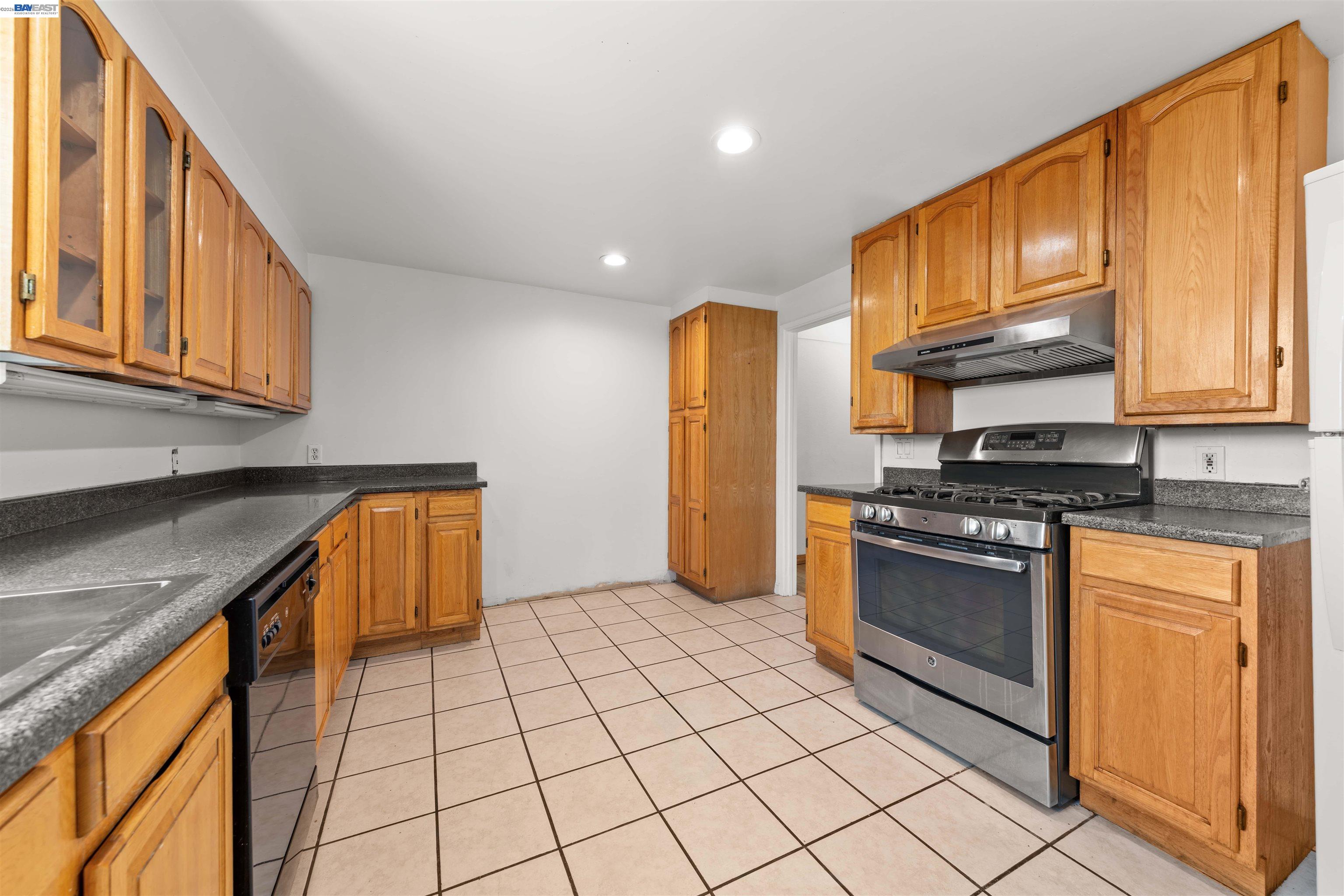 2102 Overhill Road Concord, CA 94520 - Photo 9 of 38 a kitchen with stainless steel appliances granite countertop a stove a sink and a microwave