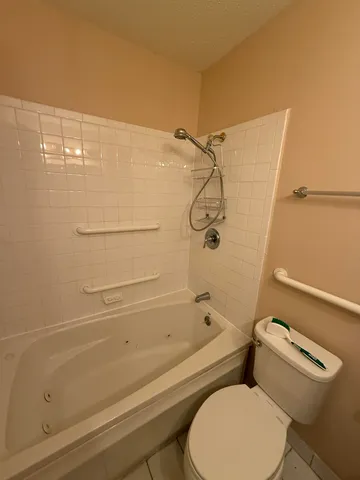 a bathroom with a toilet and a shower