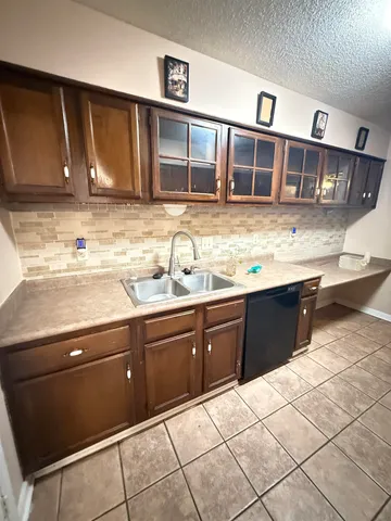a kitchen with stainless steel appliances granite countertop a sink and cabinets