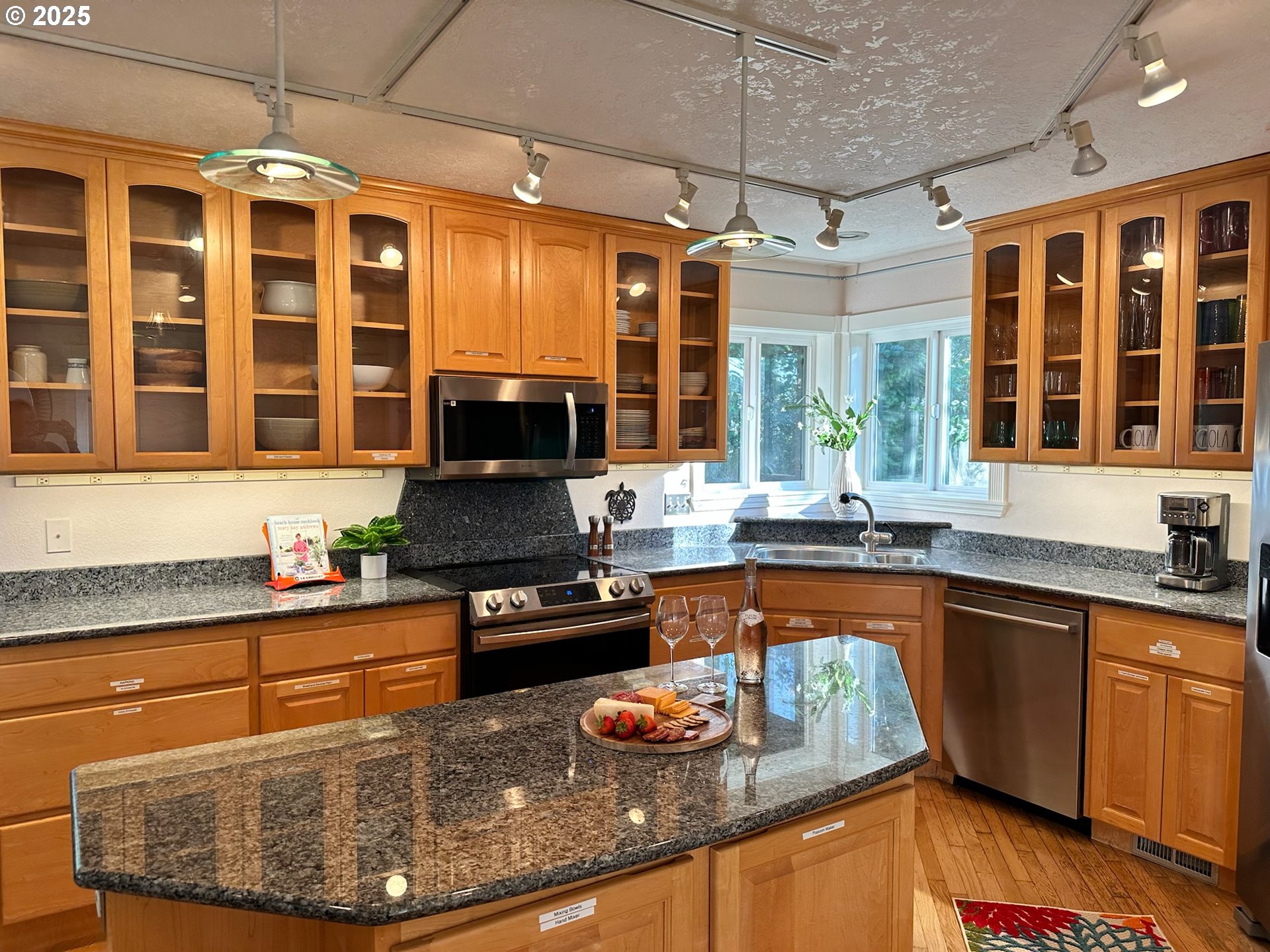 35445 Topping Road Pacific City, OR 97135 - Photo 11 of 37 a kitchen with stainless steel appliances granite countertop a sink stove and wooden cabinets