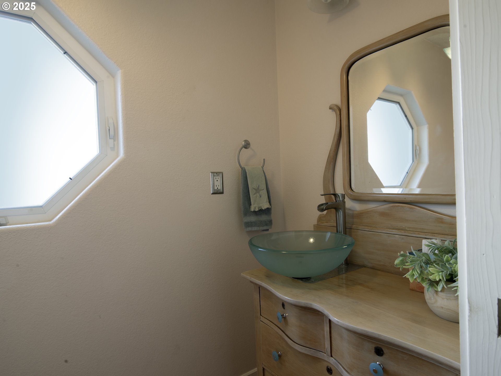 35445 Topping Road Pacific City, OR 97135 - Photo 14 of 37 a bathroom with a sink a mirror and vanity