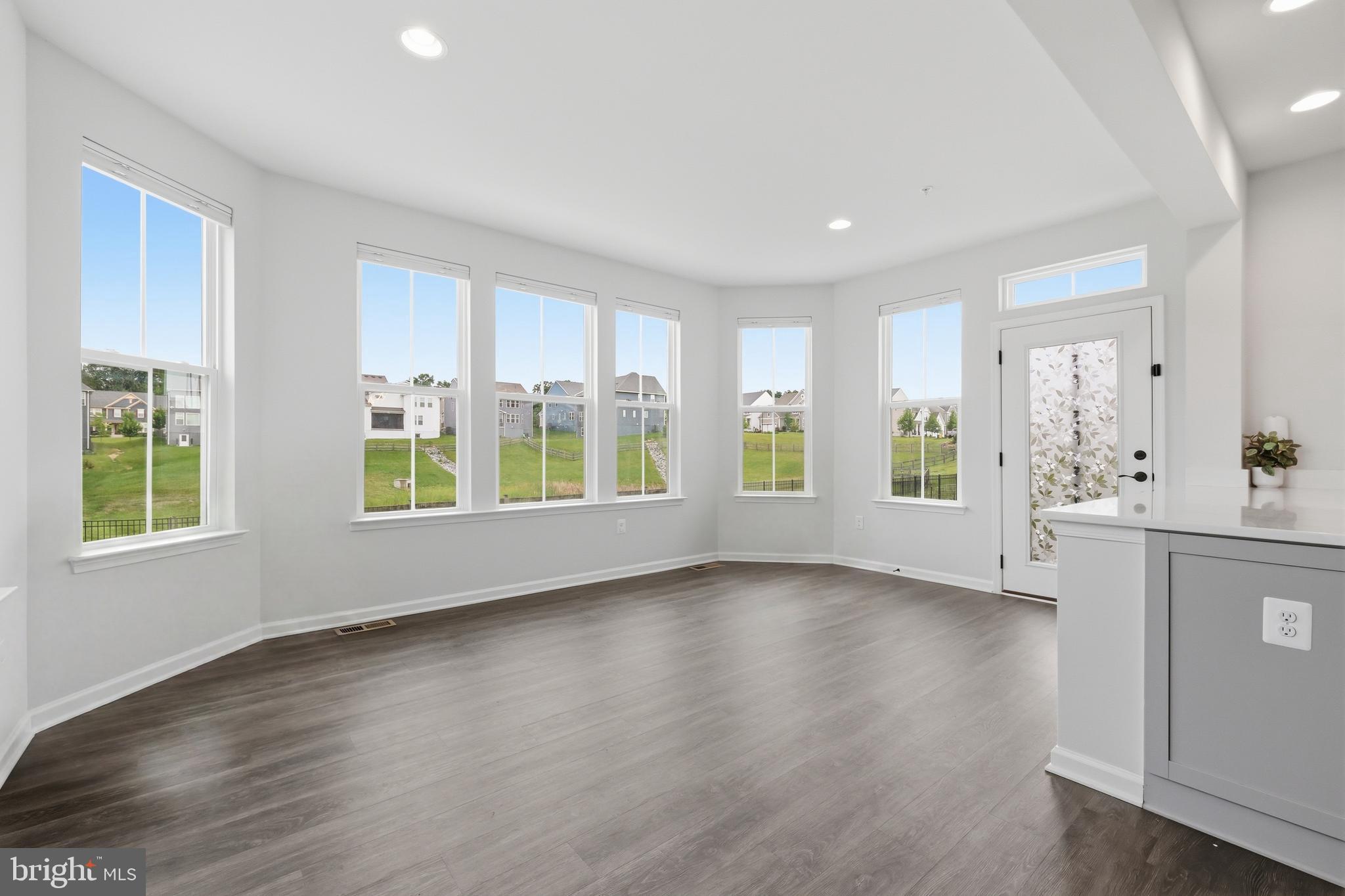 5707 Hawk Ridge Road Frederick, MD 21704 - Photo 17 of 109 a view of an empty room with window and wooden floor