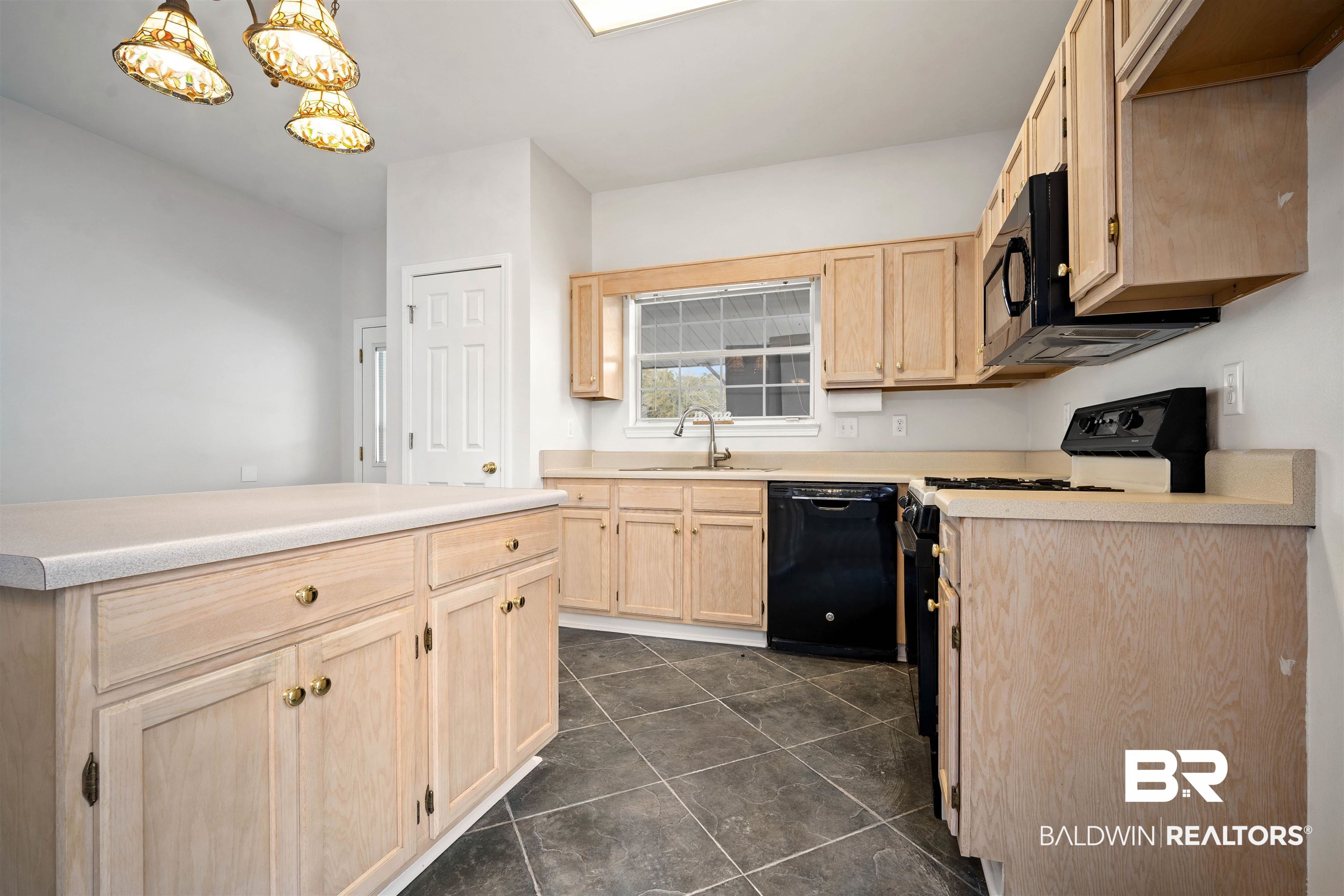 250 North Spring Lake Drive Mobile, AL 36695 - Photo 8 of 29 Kitchen with light brown cabinetry, black appliances, hanging light fixtures, and light countertops