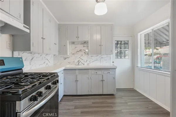 a kitchen with granite countertop a stove and a sink
