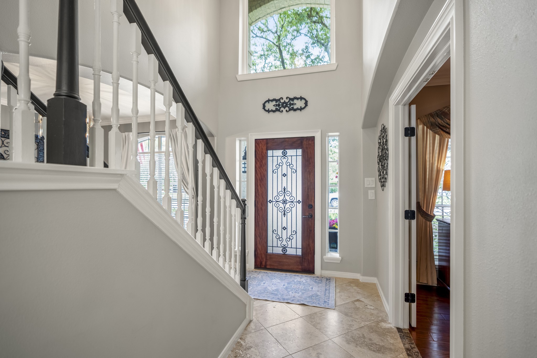 20235 Eden Pines Spring, TX 77379 - Photo 17 of 50 Back at the foyer, the tour pauses for one more look at the front of the home before heading upstairs. From here, the office sits just off the entry, the staircase rises along the left, and the front door stays in view below—helping reorient you before the tour continues to the game room, primary suite & secondary bedrooms on the second floor.