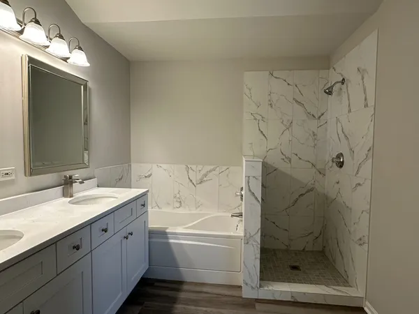 a bathroom with a granite countertop sink a toilet and shower