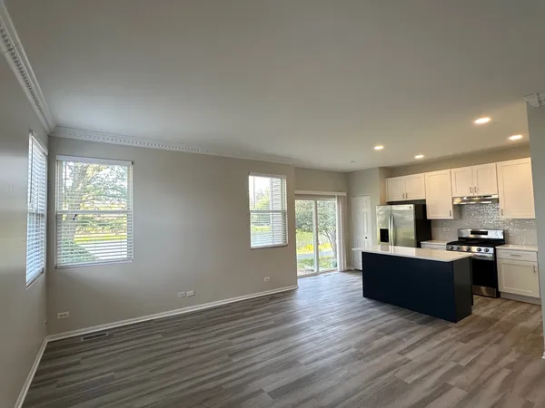 a view of kitchen and kitchen with wooden floor