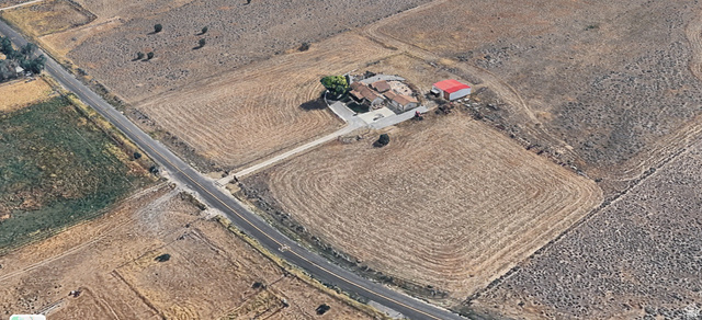 1061 Copper Street Stockton, UT 84071 - Photo 42 of 43 Expansive property featuring a central residence, a separate red-roofed outbuilding, and a paved private drive