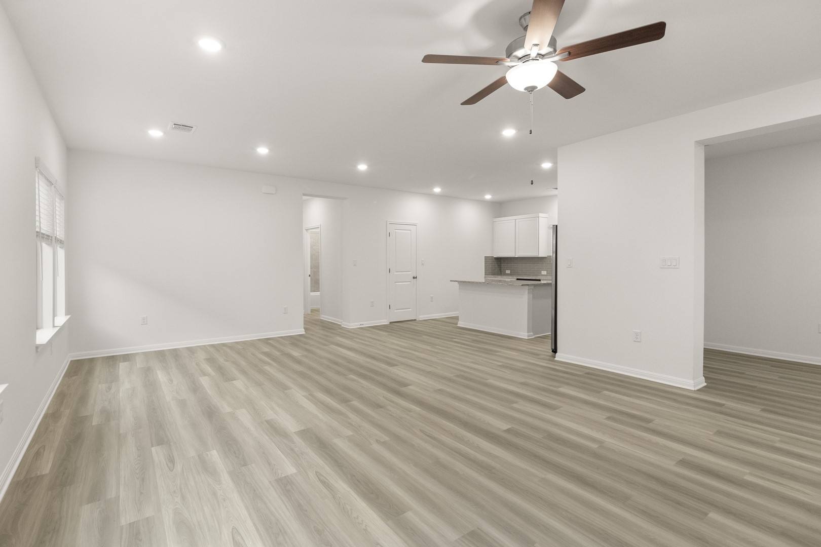 18605 Emu Lane Manor, TX 78653 - Photo 7 of 27 Open concept living space featuring light-toned flooring, recessed lighting, and a ceiling fan