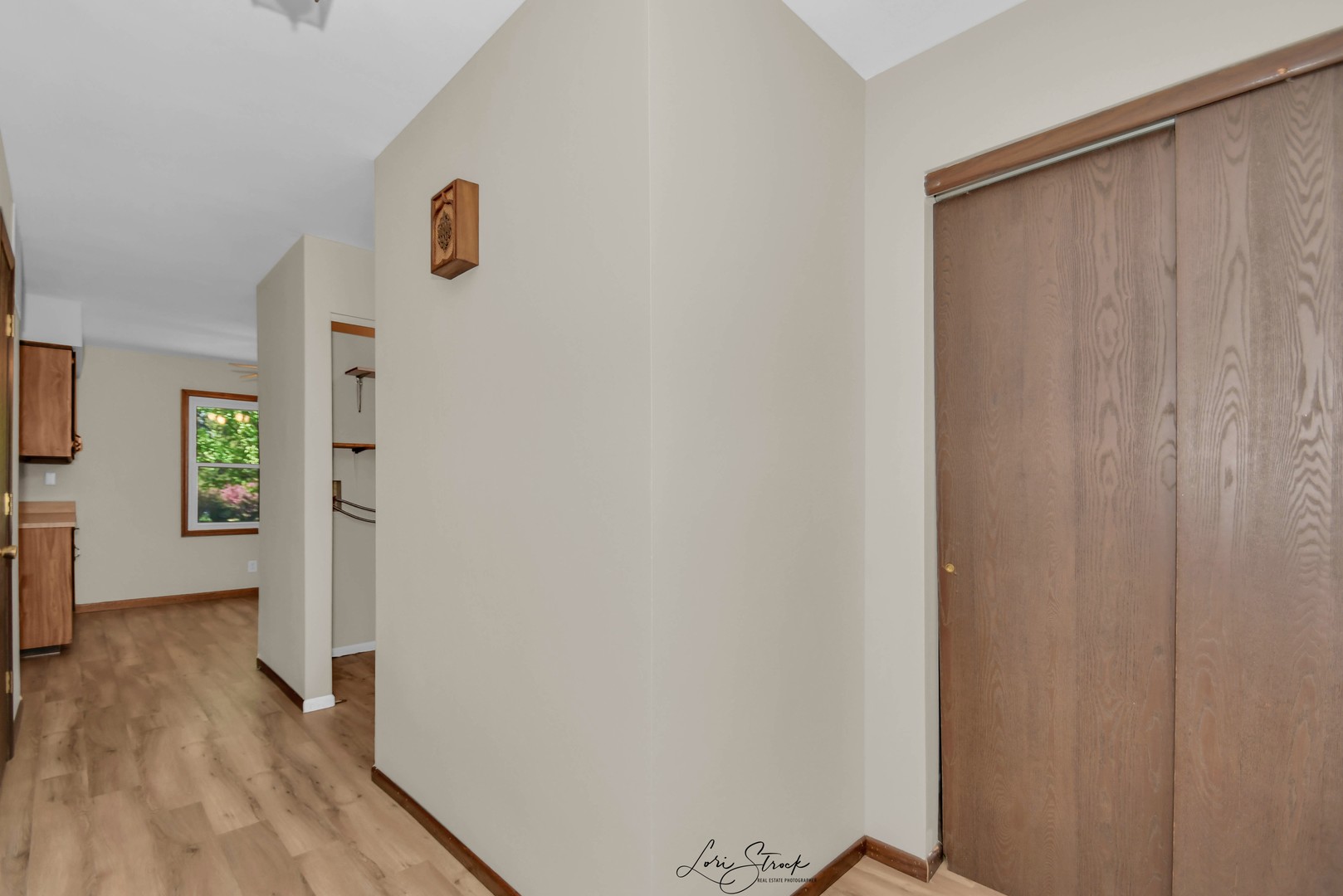869 Heather Drive Bourbonnais, IL 60914 - Photo 9 of 23 a view of a hallway with wooden floor and a bathroom