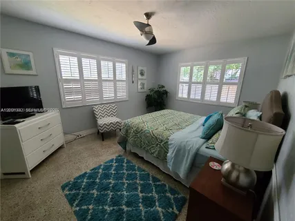 a bed room with furniture and a window