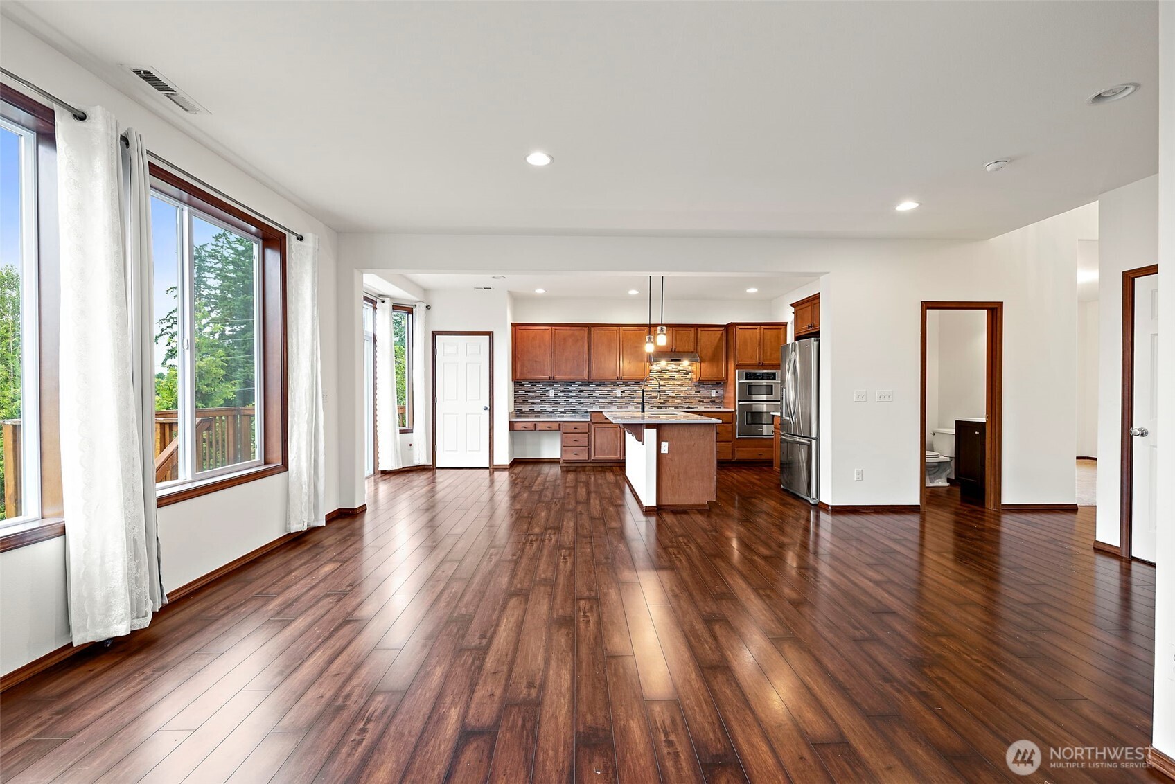 22820 41st Drive Southeast Bothell, WA 98021 - Photo 11 of 38 a living room with stainless steel appliances wooden floor large window and kitchen view