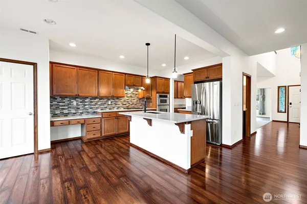 a kitchen with wooden floors and white appliances