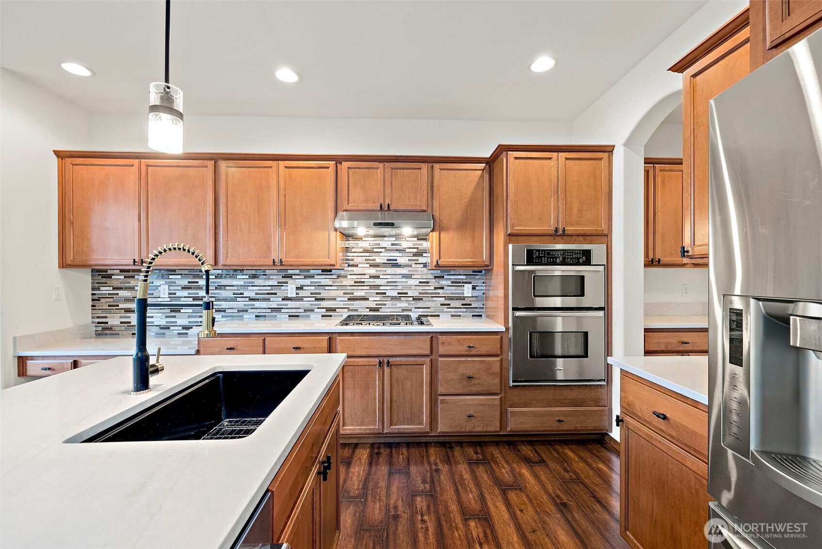 22820 41st Drive Southeast Bothell, WA 98021 - Photo 19 of 38 a kitchen with kitchen island granite countertop a sink appliances cabinets and counter space